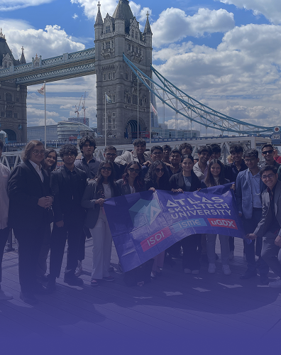 students group visit at Tower Bridge London with Atlas SkillTech University banner