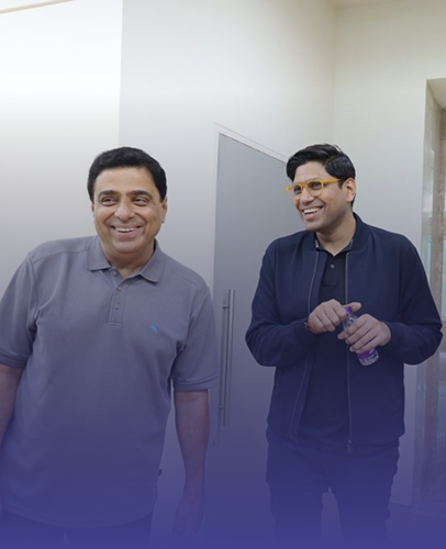 two professionals smiling and talking in office environment