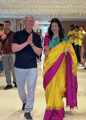 business leaders walking together at corporate event with audience in background