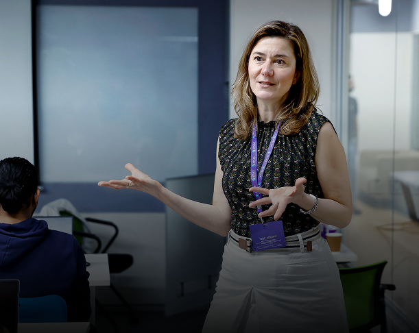 female instructor teaching students in classroom during interactive session