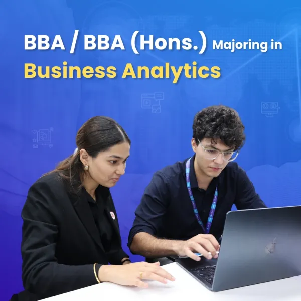 BBA and BBA Hons Business Analytics students working on laptop learning data analysis skills