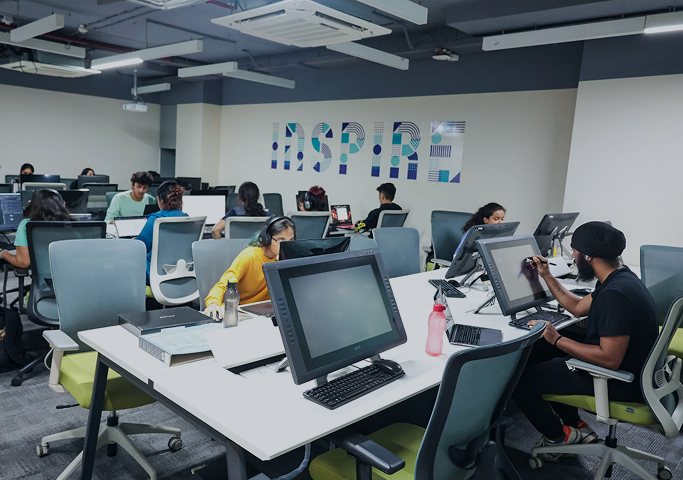 Students building digital projects on pen displays and laptops in the uGDX technology lab