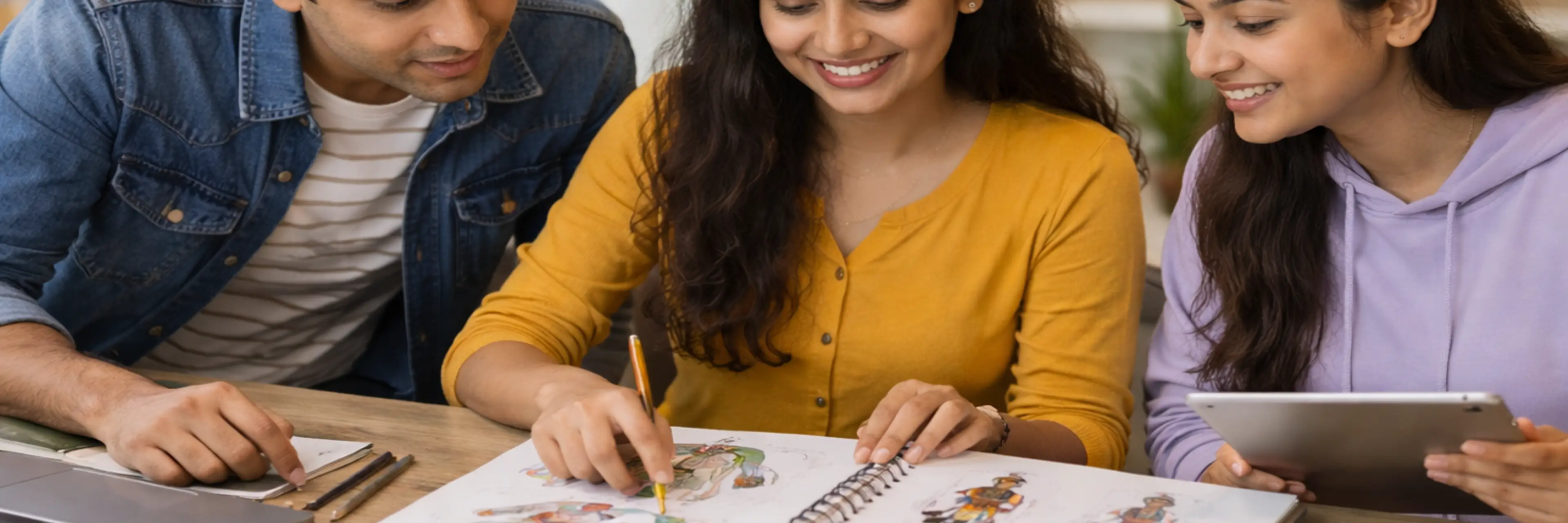 A Grade 12 student building a B Des portfolio with sketches, notes, and design projects spread across a workspace